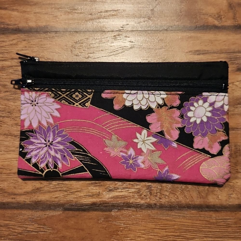 Pink floral cosmetic bag or wallet. 2 zippered compartment